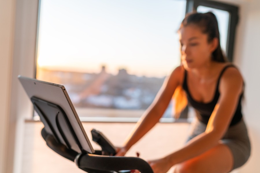 Woman on Indoor Bike | THEFITCLUBNETWORK.COM